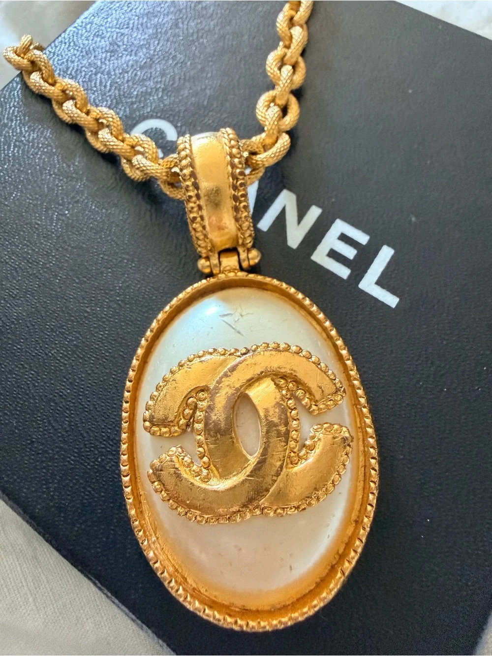 CHANEL Gold and White Oval CC Pendant Necklace